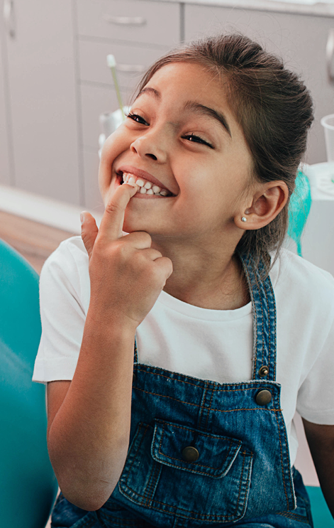 Smiling girl showing her clean teeth